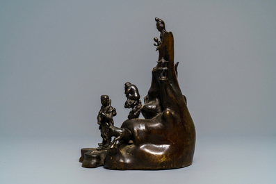 A large Chinese bronze group with Guanyin with child on a rock, Ming