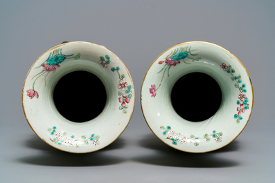 A pair of Chinese yellow-ground famille rose relief-decorated vases, 19th C.