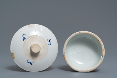 A pair of Chinese blue and white candlesticks and three famille rose figures of boys, 19th C.