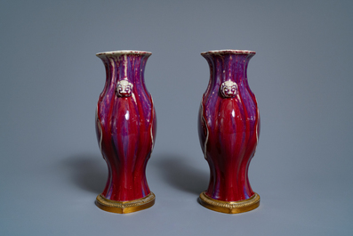 A pair of Chinese flamb&eacute;-glazed vases on gilt bronze stands, 18/19th C.