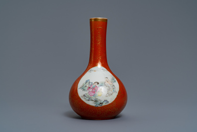 Un vase de forme bouteille en porcelaine de Chine famille rose &agrave; fond corail, marque de Qianlong, 19/20&egrave;me