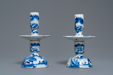 A pair of Chinese blue and white candlesticks and three famille rose figures of boys, 19th C.