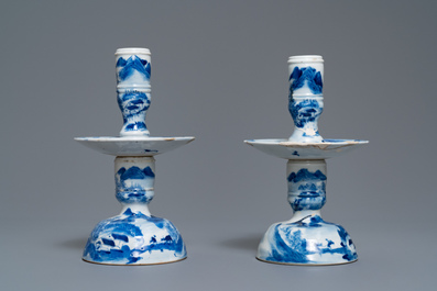 A pair of Chinese blue and white candlesticks and three famille rose figures of boys, 19th C.