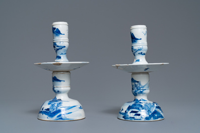A pair of Chinese blue and white candlesticks and three famille rose figures of boys, 19th C.