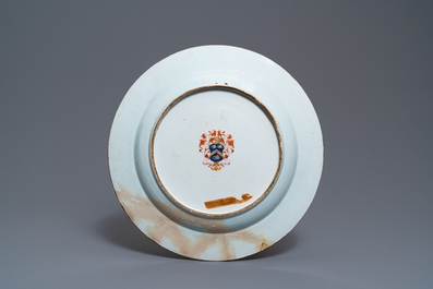 A Chinese grisaille 'Return from the hunt' dish with a coat of arms on the back, Qianlong