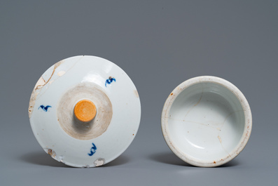 A pair of Chinese blue and white candlesticks and three famille rose figures of boys, 19th C.