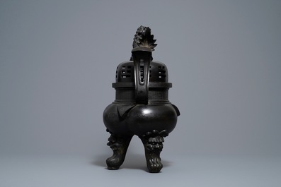 A large Chinese bronze incense burner and cover on carved wooden stand, Ming