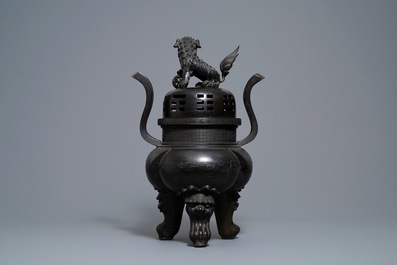 A large Chinese bronze incense burner and cover on carved wooden stand, Ming