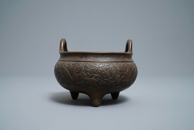 A Chinese bronze tripod 'phoenix and peony' censer, Xuande mark, 18th C.