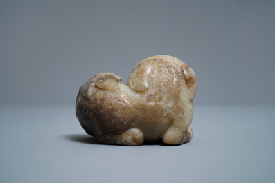 A Chinese pale grey-brown jade model of a Buddhist lion, 19/20th C.