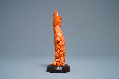 A Chinese carved red coral group of Guanyin with child, 19th C.