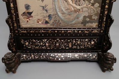 A large Chinese mother-of-pearl-inlaid wooden screen with silk embroidery, 19th C.