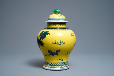 A Chinese yellow-ground famille verte vase and cover with Buddhist lions, 19th C.