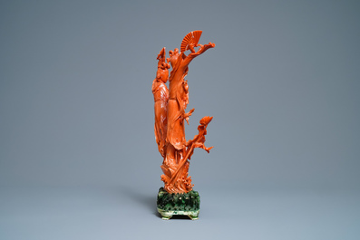 A large Chinese carved red coral group of two ladies with fans, 19th C.