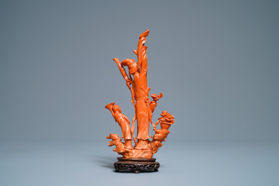 A Chinese carved red coral group of a lady and child, 19th C.