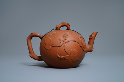 A large Chinese Yixing stoneware teapot with applied grape vines design, Kangxi