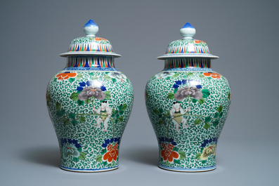 A pair of Chinese wucai vases and covers, Wanli mark, 19th C.