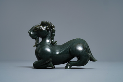 A Chinese spinach green jade model of a recumbent ram, 19/20th C.