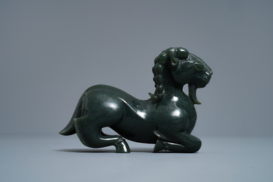 A Chinese spinach green jade model of a recumbent ram, 19/20th C.