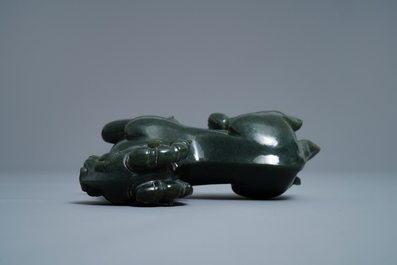 A Chinese spinach green jade model of a recumbent ram, 19/20th C.