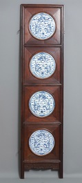 A Chinese wooden room divider with blue and white 'dragon' plaques, 19th C.