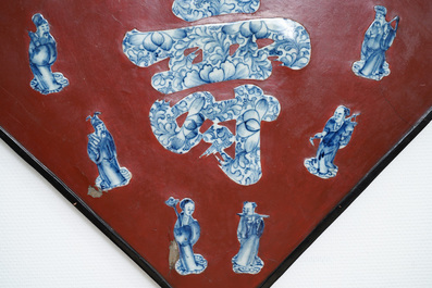 A Chinese red-lacquered plaque with blue and white porcelain inserts, 19/20th C.