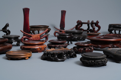 A collection of 33 Chinese carved wood stands, 19/20th C.