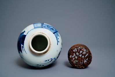 A Chinese blue and white ginger jar with figures in a landscape and a wooden cover, Transitional period