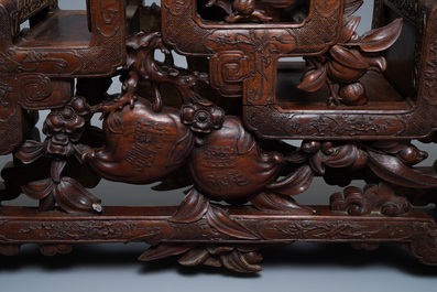 A Chinese finely carved wooden display stand, 19th C.