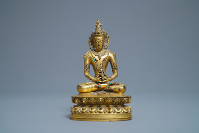 A Chinese coral- and turquoise-inlaid gilt bronze figure of Buddha Amitayus, 18/19th C.