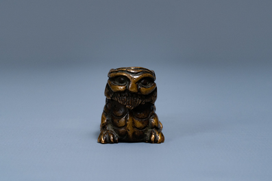 A Chinese bronze 'mythical beast' scroll weight, Ming