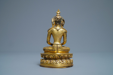 A Chinese coral- and turquoise-inlaid gilt bronze figure of Buddha Amitayus, 18/19th C.