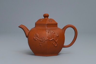 Een Chinese Yixing steengoed theepot met prunus in reli&euml;f, Kangxi