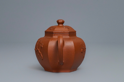 A Chinese Yixing stoneware teapot and cover with applied prunus design, Kangxi