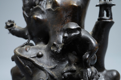 A large Chinese bronze group with Guanyin with child on a rock, Ming