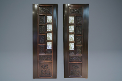 A Chinese wooden closet with 23 qianjiang cai plaques, 19/20th C.