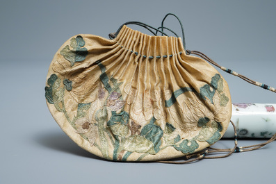 A Chinese famille rose opium pipe with silk pouch, 19th C.