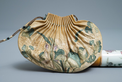 A Chinese famille rose opium pipe with silk pouch, 19th C.