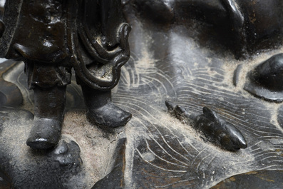 A large Chinese bronze group with Guanyin with child on a rock, Ming