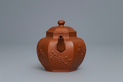 Een Chinese Yixing steengoed theepot met prunus in reli&euml;f, Kangxi