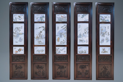 A Chinese wooden closet with 23 qianjiang cai plaques, 19/20th C.