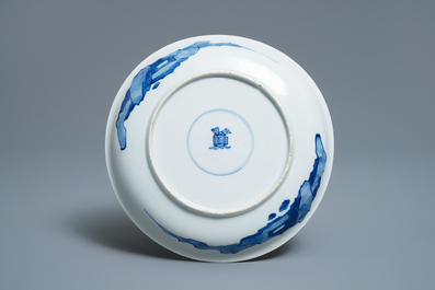 A Chinese blue and white semi-eggshell plate with a lady carrying a child, Kangxi