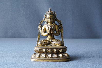 A Sino-Tibetan inlaid gilt bronze figure of Buddha, Ming