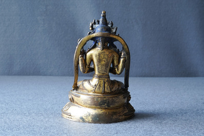 A Sino-Tibetan inlaid gilt bronze figure of Buddha, Ming