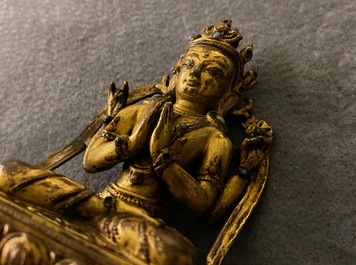 A Sino-Tibetan inlaid gilt bronze figure of Buddha, Ming