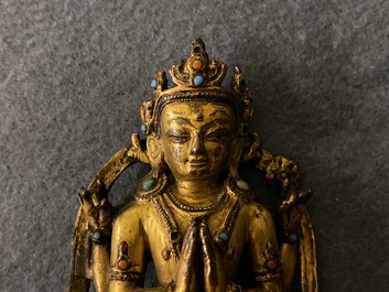 A Sino-Tibetan inlaid gilt bronze figure of Buddha, Ming