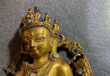 A Sino-Tibetan inlaid gilt bronze figure of Buddha, Ming