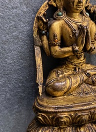 A Sino-Tibetan inlaid gilt bronze figure of Buddha, Ming