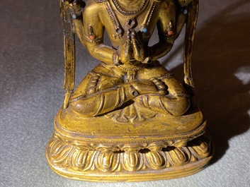 A Sino-Tibetan inlaid gilt bronze figure of Buddha, Ming