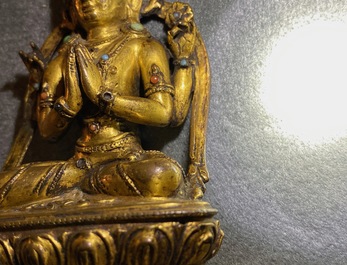 A Sino-Tibetan inlaid gilt bronze figure of Buddha, Ming